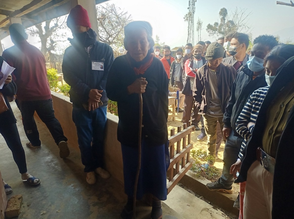 84 years old senior citizen standing in the queue to cast her vote at Tening