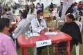 Medical services to an elderly woman at the health mela, Chedema